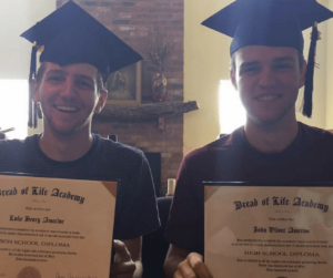 Two boys with diplomas, graduation